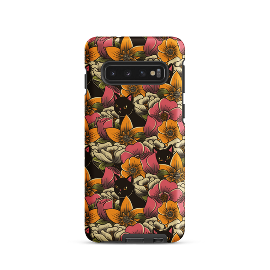The image features a repeating pattern of colorful flowers in pink, yellow, and cream hues with lush green foliage. Interspersed among the flowers are playful black cats with bright eyes. The design has a whimsical and vibrant feel, ideal for various products like t-shirts, stickers, coffee cups, and skateboards. The style is reminiscent of traditional floral art blended with playful elements of animal decor.
