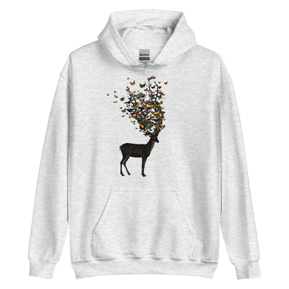 The image depicts a dark, silhouetted deer standing on a neutral background. Instead of branches, its antlers transform into a swirling cloud of vibrant, colorful butterflies that extend upwards and outward. The mix of organic and ethereal elements creates a captivating and whimsical visual contrast.