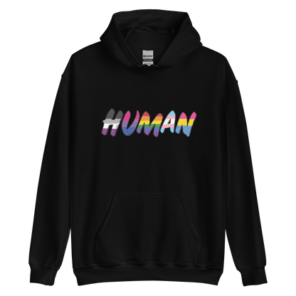 The image displays the word 'HUMAN' in bold, capitalized letters filled with colorful pride flag patterns. The colors within the letters represent different LGBTQ+ pride flags, symbolizing inclusivity and diversity. The background is solid black, which makes the colorful patterns stand out more vibrantly.