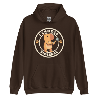 A cute, cartoonish burnt yellow capybara stands holding a spiked mace with a determined expression. Surrounding it is a circular design with the text 'I CHOOSE VIOLENCE' and two small skulls on either side, giving it a humorous yet ironic tone.