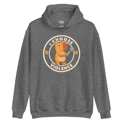 A cute, cartoonish burnt yellow capybara stands holding a spiked mace with a determined expression. Surrounding it is a circular design with the text 'I CHOOSE VIOLENCE' and two small skulls on either side, giving it a humorous yet ironic tone.