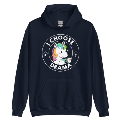 A cartoon unicorn with rainbow-colored mane holds a cup of tea and a heart, encircled by the words 'I Choose Drama'. Two small clouds with lightning bolts flank the unicorn, adding a playful yet slightly edgy vibe. The design is bold and whimsical with a pop-art influence.