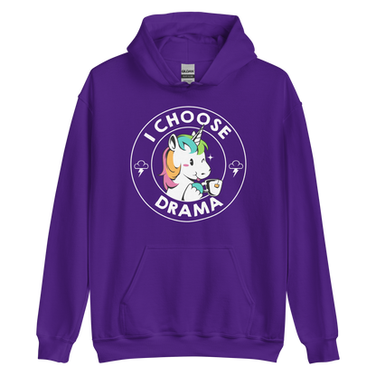 A cartoon unicorn with rainbow-colored mane holds a cup of tea and a heart, encircled by the words 'I Choose Drama'. Two small clouds with lightning bolts flank the unicorn, adding a playful yet slightly edgy vibe. The design is bold and whimsical with a pop-art influence.