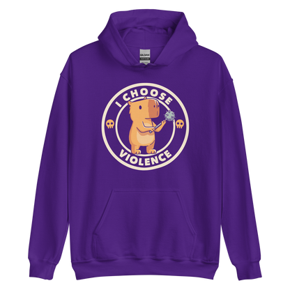 A cute, cartoonish burnt yellow capybara stands holding a spiked mace with a determined expression. Surrounding it is a circular design with the text 'I CHOOSE VIOLENCE' and two small skulls on either side, giving it a humorous yet ironic tone.