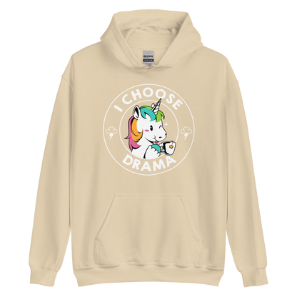 A cartoon unicorn with rainbow-colored mane holds a cup of tea and a heart, encircled by the words 'I Choose Drama'. Two small clouds with lightning bolts flank the unicorn, adding a playful yet slightly edgy vibe. The design is bold and whimsical with a pop-art influence.