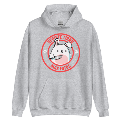 A cute white cartoon bunny with a pink belly stands holding a large kitchen knife in one paw. Surrounding the bunny is a red circular border with the words 'DEBISTE TIRAR MÁS FOTOS'. Small skull icons are on either side of the circle. The overall tone is a mix of adorable and ironic humor.