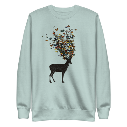 The image depicts a dark, silhouetted deer standing on a neutral background. Instead of branches, its antlers transform into a swirling cloud of vibrant, colorful butterflies that extend upwards and outward. The mix of organic and ethereal elements creates a captivating and whimsical visual contrast.