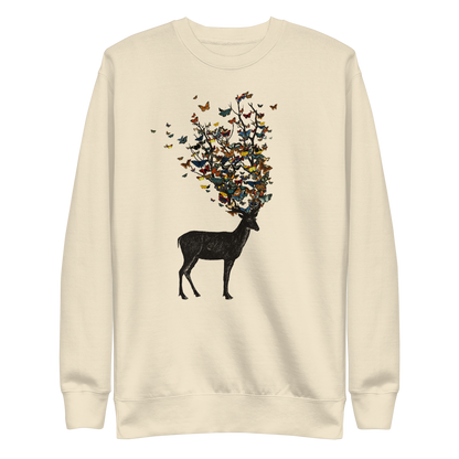The image depicts a dark, silhouetted deer standing on a neutral background. Instead of branches, its antlers transform into a swirling cloud of vibrant, colorful butterflies that extend upwards and outward. The mix of organic and ethereal elements creates a captivating and whimsical visual contrast.