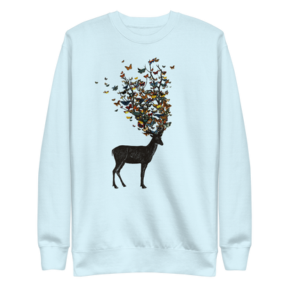 The image depicts a dark, silhouetted deer standing on a neutral background. Instead of branches, its antlers transform into a swirling cloud of vibrant, colorful butterflies that extend upwards and outward. The mix of organic and ethereal elements creates a captivating and whimsical visual contrast.