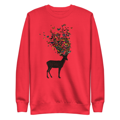 The image depicts a dark, silhouetted deer standing on a neutral background. Instead of branches, its antlers transform into a swirling cloud of vibrant, colorful butterflies that extend upwards and outward. The mix of organic and ethereal elements creates a captivating and whimsical visual contrast.