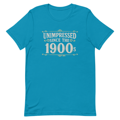 Vintage-style graphic with the phrase “Unimpressed Since the 1900s” in bold distressed lettering, decorated with ornate flourishes and a retro color palette.