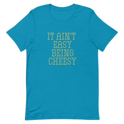 Bold dotted typography spells out ‘It Ain’t Easy Being Cheesy’ in a playful retro style on a yellow background. This funny design mixes wordplay with foodie humor, perfect for pun lovers, cheese fans, retro humor enthusiasts, and anyone who embraces the cringe with pride. A great quirky gift for cheese lovers and humor fans alike.