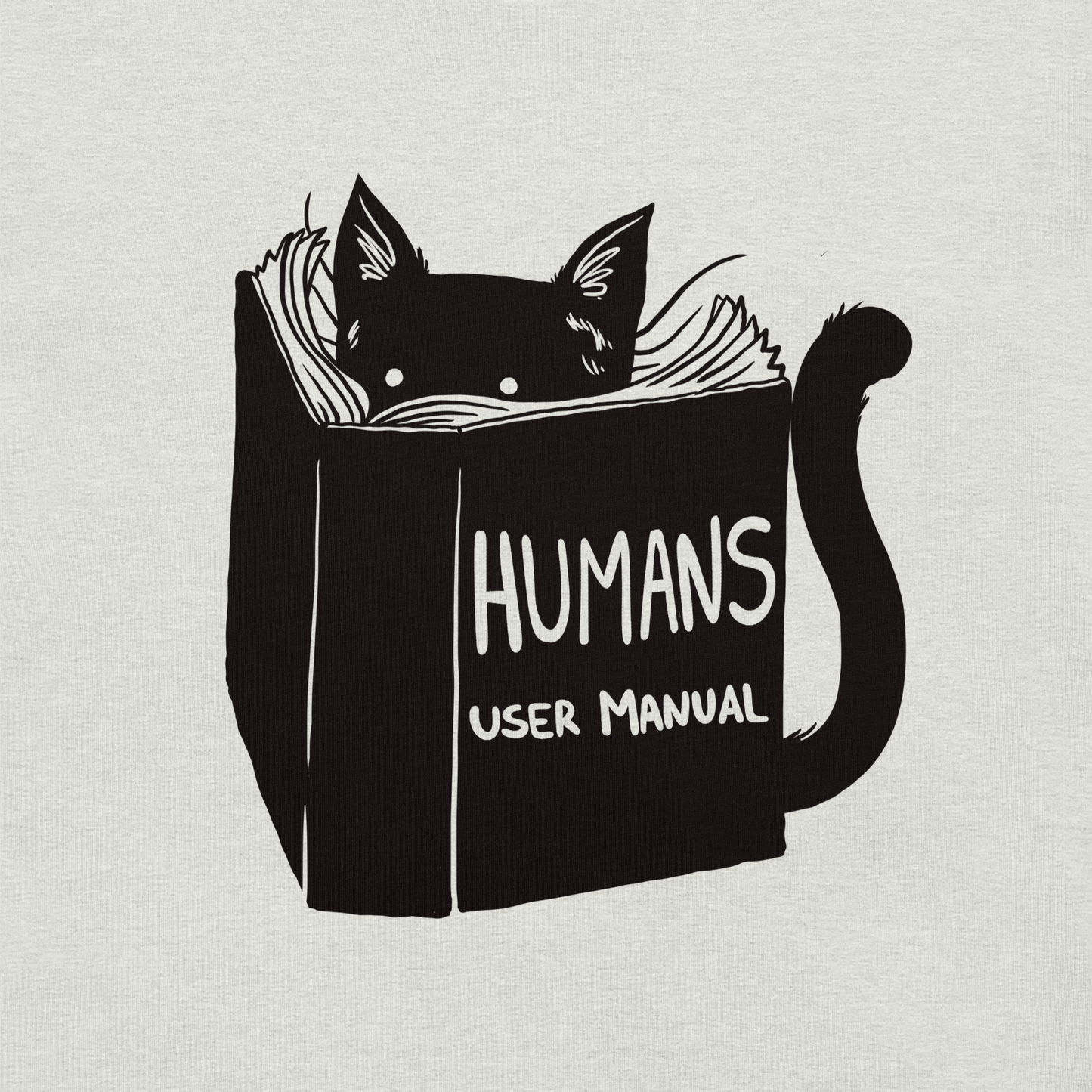 A kitten peeking out from behind a huge book titled "Humans: User Manual". This design plays on the idea that cats are trying to figure out how to control us. Perfect for cat lovers, book fans, and anyone who enjoys lighthearted humor in prints.
