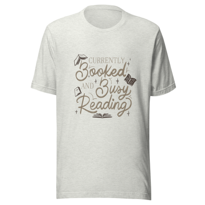 A warm hand-lettered typography featuring the phrase ‘Currently Booked and Busy Reading’, accented with delicate book illustrations and subtle sparkles on a dark background. A cozy, elegant design that celebrates the joy of reading, perfect for book lovers, students, introverts, and anyone who would rather be reading.