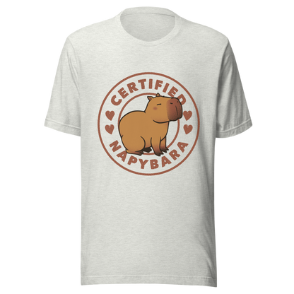 An art piece in warm beige and brown tones featuring a relaxed, sleepy capybara sitting peacefully beside the phrase “Certified Napybara”. A cozy, humorous design perfect for anyone who relates to slow days, loves capybaras, and fully embraces the art of taking naps.