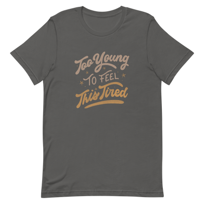The artwork features the vintage-style lettering "Too Young To Feel This Tired," with touches of beige and gold, decorated with small stars. This playful phrase conveys the feeling of premature fatigue with an ironic and stylish touch. Ideal for young adults, students, and anyone who can relate to the daily struggle between energy and exhaustion.