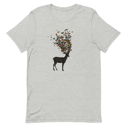 The image depicts a dark, silhouetted deer standing on a neutral background. Instead of branches, its antlers transform into a swirling cloud of vibrant, colorful butterflies that extend upwards and outward. The mix of organic and ethereal elements creates a captivating and whimsical visual contrast.