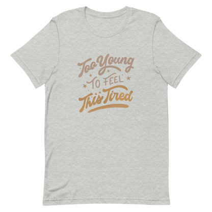 The artwork features the vintage-style lettering "Too Young To Feel This Tired," with touches of beige and gold, decorated with small stars. This playful phrase conveys the feeling of premature fatigue with an ironic and stylish touch. Ideal for young adults, students, and anyone who can relate to the daily struggle between energy and exhaustion.