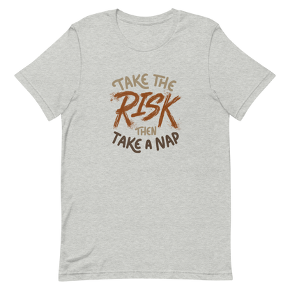 The artwork features bold lettering, "Take the Risk Then Take a Nap," with the word "Risk" highlighted in bold, energetic brushstrokes. This composition plays with the contrast between courage and rest, showing that taking risks is important, but so is recharging your batteries. Ideal for fans of fun quotes and those seeking lighthearted inspiration with a dash of humor.