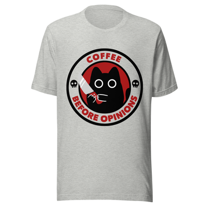 The illustration, in shades of red and black, features a wide-eyed black kitten holding a knife at the centre. Surrounding the cat is the phrase ‘Coffee Before Opinions’. A fun and cheeky gift for those who love cats and can’t function without their coffee.