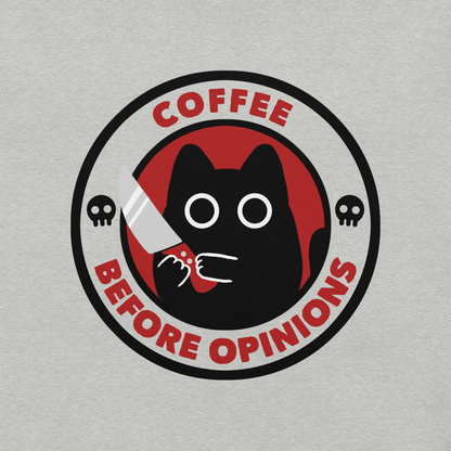 The illustration, in shades of red and black, features a wide-eyed black kitten holding a knife at the centre. Surrounding the cat is the phrase ‘Coffee Before Opinions’. A fun and cheeky gift for those who love cats and can’t function without their coffee.