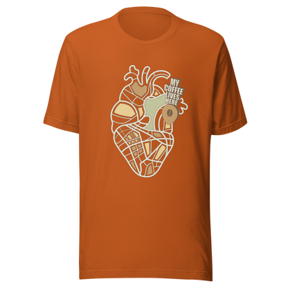 An anatomical heart illustrated like a map, marked with a small coffee-bean pin beside the phrase “My Coffee Lives Here”. A symbolic and cozy design that blends warmth and creativity, perfect for coffee lovers who treat their favorite brew as the fuel that keeps their heart beating.