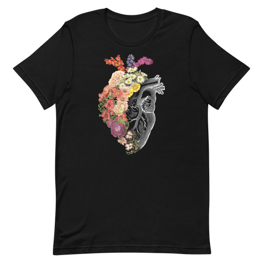 The design is an intricate and anatomical drawing of a human heart on a black background. The left side of the heart morphs into a vibrant assortment of colorful flowers, including roses, daisies, and other blooming blossoms, creating a striking contrast between the realistic and the surreal, symbolizing the harmony between nature and humanity.