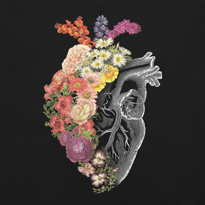 The design is an intricate and anatomical drawing of a human heart on a black background. The left side of the heart morphs into a vibrant assortment of colorful flowers, including roses, daisies, and other blooming blossoms, creating a striking contrast between the realistic and the surreal, symbolizing the harmony between nature and humanity.