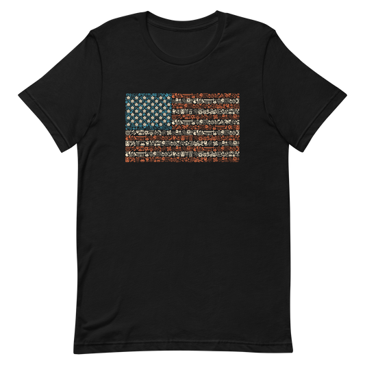 American flag illustration made entirely of retro video game icons, controllers, characters, and symbols in blue, red, and beige, arranged to form the stars and stripes.