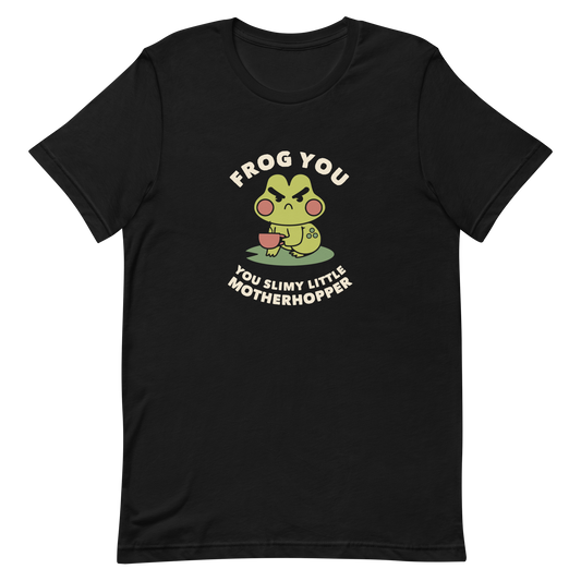 The design features a cartoonish green frog with exaggerated angry features, holding a teacup. The frog has round red cheeks. Above it, text says 'Frog You' and below, 'You Slimy Little Motherhopper'. The style is playful and humorous, reminiscent of cute comic art.