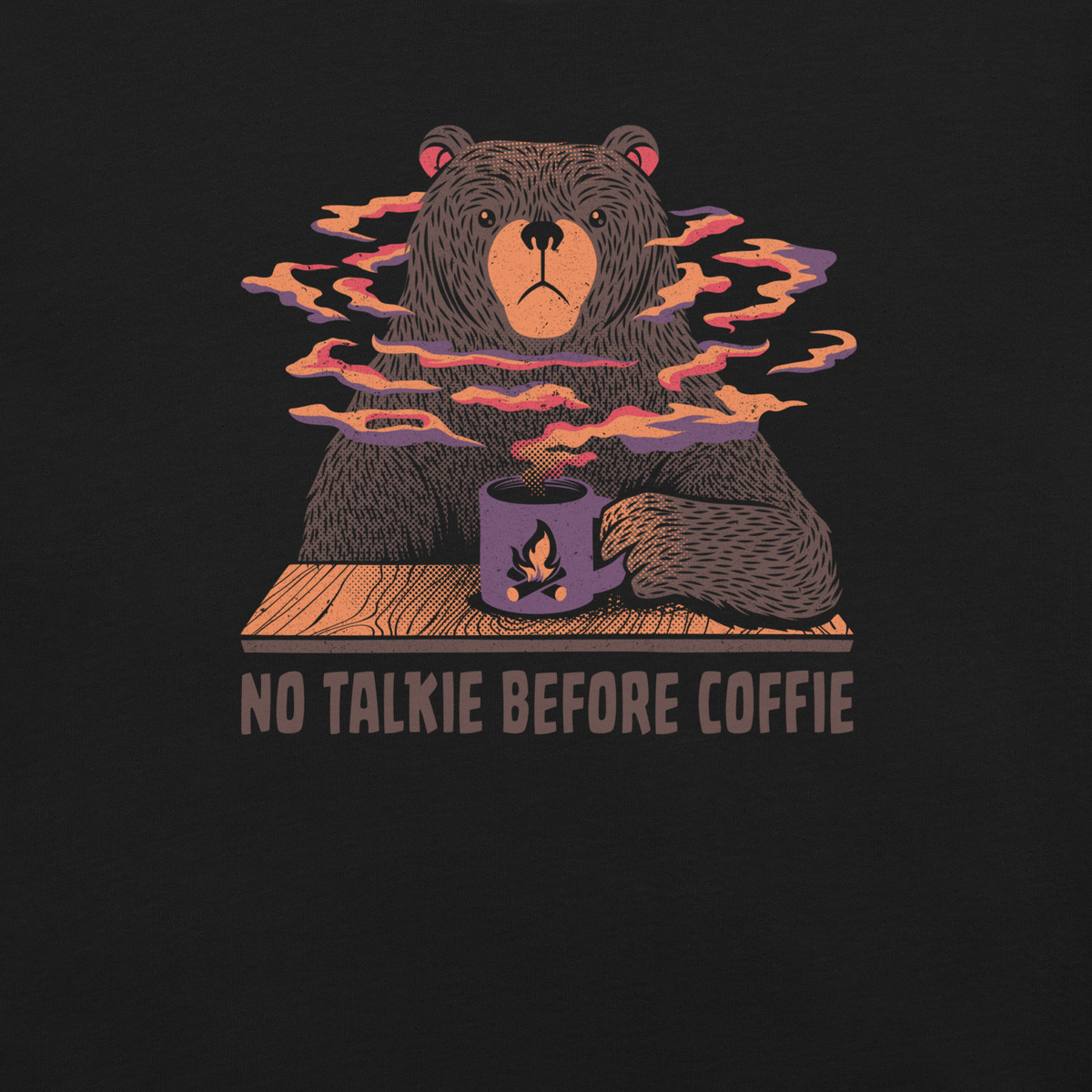 A large brown bear holding a purple coffee cup with a campfire design, with steam rising as if the coffee were piping hot. Below it appears the phrase ‘No Talkie Before Coffie’. A fun design for coffee lovers and anyone who isn’t ready to talk before their first cup.