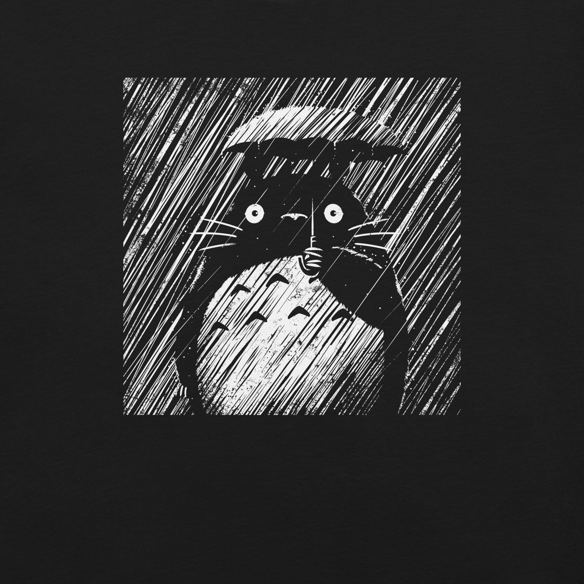 A large forest spirit stands still in the rain, holding a tiny umbrella while soaking in the storm. This black and white design captures a quiet, emotional moment with a vintage, textured style.
