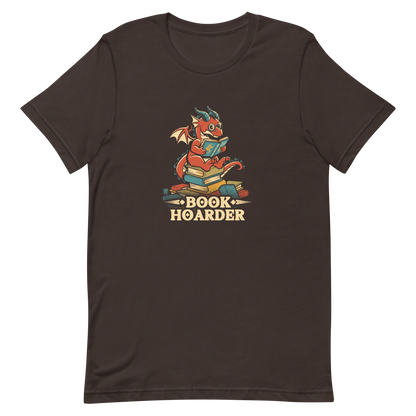 Perched atop his treasure trove of books, this red nerdy dragon is ready to devour epic adventures, magic tales, and fantasy worlds. The words 'BOOK HOARDER' are placed at the bottom of the design.