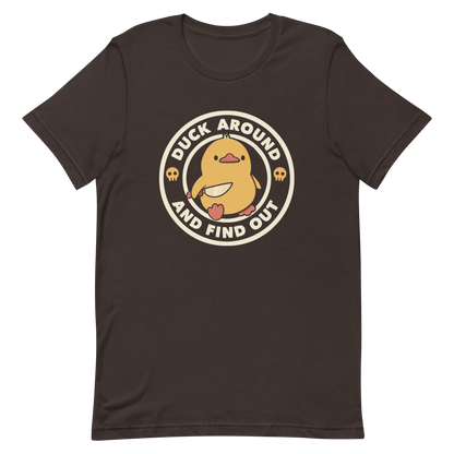 A cute yellow duck holding a small knife, around it the text "Duck Around And Find Out". An art that mixes humor with the temperament of ducks.