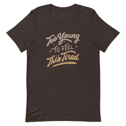The artwork features the vintage-style lettering "Too Young To Feel This Tired," with touches of beige and gold, decorated with small stars. This playful phrase conveys the feeling of premature fatigue with an ironic and stylish touch. Ideal for young adults, students, and anyone who can relate to the daily struggle between energy and exhaustion.