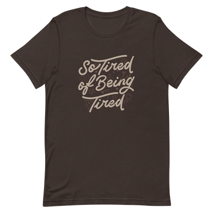 The artwork features the retro-style lettering "So Tired of Being Tired" surrounded by small icons like stars, hearts, clouds, and spider webs. This composition expresses the feeling of constant fatigue in a fun and stylish way. Ideal for those who bring humor to life and those who experience exhaustion in a lighthearted and humorous way.