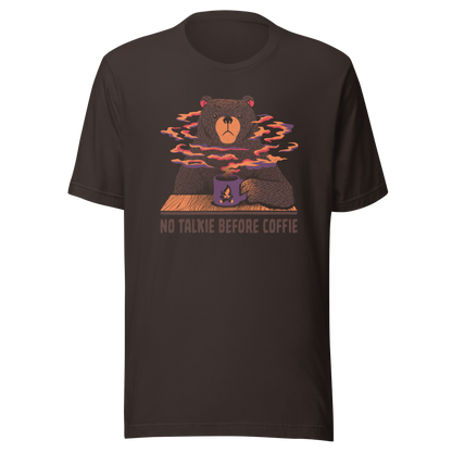 A large brown bear holding a purple coffee cup with a campfire design, with steam rising as if the coffee were piping hot. Below it appears the phrase ‘No Talkie Before Coffie’. A fun design for coffee lovers and anyone who isn’t ready to talk before their first cup.