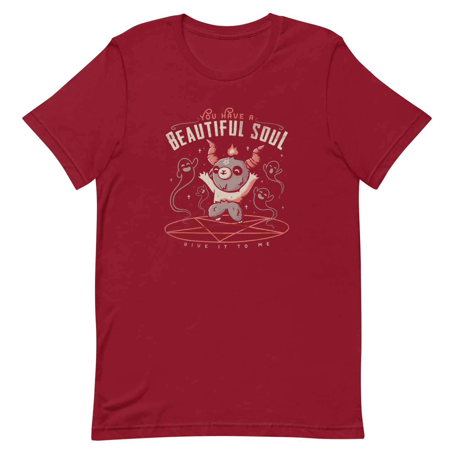 This design features a cute, cartoonish character with horns and a pentagram on its forehead, standing on a red circle with ghost-like figures surrounding it. Above the character, the text reads 'You have a beautiful soul,' and below, 'Give it to me.' The design contrasts dark and cute imagery with playful lettering.