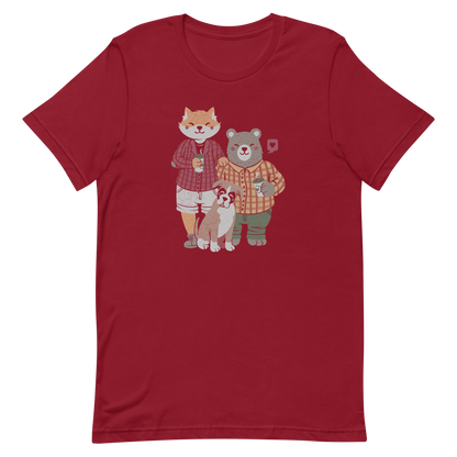 A beautiful family made up of a little red fox, a gray bear wearing plaid shirts and having a coffee with their boxer dog. An art that shows that families can be different what matters is love.