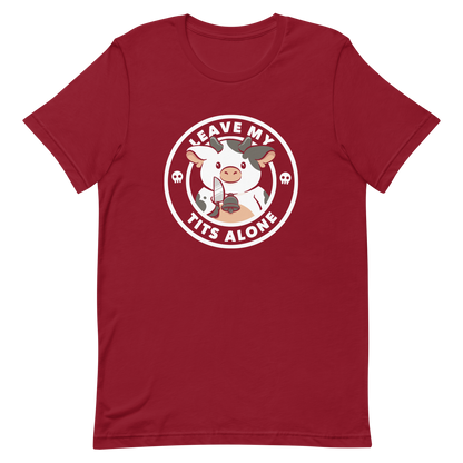 A quirky stamp-style design featuring a cute spotted cow holding a knife with the phrase “Leave My Tits Alone.” It mixes humor, attitude, and a playful call for animal respect. Perfect for cow lovers, fans of sassy humor, and anyone who supports animal rights.