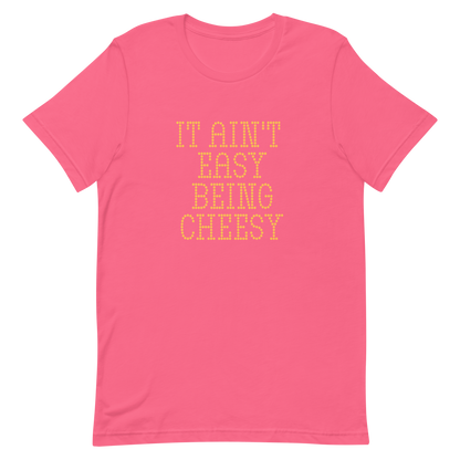 Bold dotted typography spells out ‘It Ain’t Easy Being Cheesy’ in a playful retro style on a yellow background. This funny design mixes wordplay with foodie humor, perfect for pun lovers, cheese fans, retro humor enthusiasts, and anyone who embraces the cringe with pride. A great quirky gift for cheese lovers and humor fans alike.
