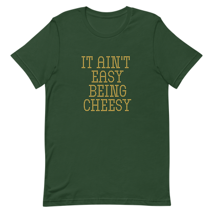 Bold dotted typography spells out ‘It Ain’t Easy Being Cheesy’ in a playful retro style on a yellow background. This funny design mixes wordplay with foodie humor, perfect for pun lovers, cheese fans, retro humor enthusiasts, and anyone who embraces the cringe with pride. A great quirky gift for cheese lovers and humor fans alike.