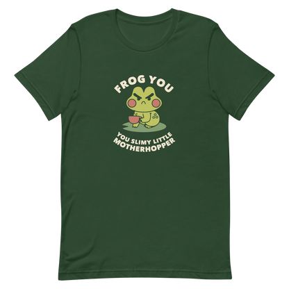 The design features a cartoonish green frog with exaggerated angry features, holding a teacup. The frog has round red cheeks. Above it, text says 'Frog You' and below, 'You Slimy Little Motherhopper'. The style is playful and humorous, reminiscent of cute comic art.