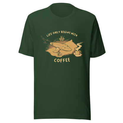 This funny illustration shows a tadpole evolving into a terrestrial creature while reaching for a cup of coffee. Paired with the phrase ‘Life Begins After Coffee Evolution’, the artwork humorously compares human evolution to our daily need for coffee.
