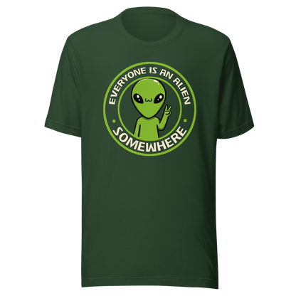 A stamp-style design of a green alien making a “V” sign, paired with the phrase “Everyone Is An Alien Somewhere”. A playful artwork about feeling different and embracing individuality.