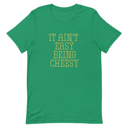 Bold dotted typography spells out ‘It Ain’t Easy Being Cheesy’ in a playful retro style on a yellow background. This funny design mixes wordplay with foodie humor, perfect for pun lovers, cheese fans, retro humor enthusiasts, and anyone who embraces the cringe with pride. A great quirky gift for cheese lovers and humor fans alike.