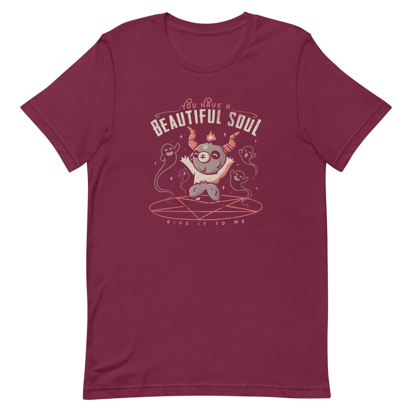 This design features a cute, cartoonish character with horns and a pentagram on its forehead, standing on a red circle with ghost-like figures surrounding it. Above the character, the text reads 'You have a beautiful soul,' and below, 'Give it to me.' The design contrasts dark and cute imagery with playful lettering.