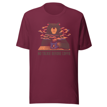 A large brown bear holding a purple coffee cup with a campfire design, with steam rising as if the coffee were piping hot. Below it appears the phrase ‘No Talkie Before Coffie’. A fun design for coffee lovers and anyone who isn’t ready to talk before their first cup.