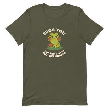 The design features a cartoonish green frog with exaggerated angry features, holding a teacup. The frog has round red cheeks. Above it, text says 'Frog You' and below, 'You Slimy Little Motherhopper'. The style is playful and humorous, reminiscent of cute comic art.