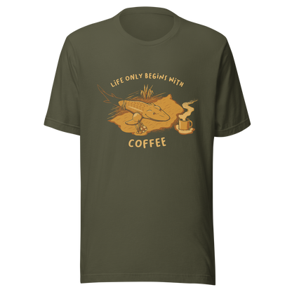 This funny illustration shows a tadpole evolving into a terrestrial creature while reaching for a cup of coffee. Paired with the phrase ‘Life Begins After Coffee Evolution’, the artwork humorously compares human evolution to our daily need for coffee.